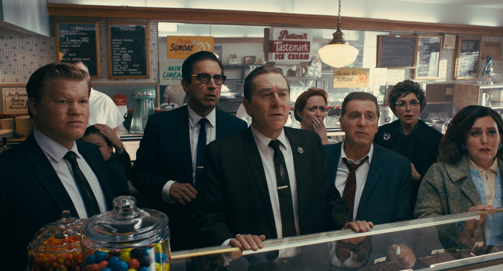 (From l to r) During a break in the trial of Jimmy Hoffa, Chuckie O’Brien (Jesse Plemons), Bill Bufalino (Ray Romano), Frank Sheeran (Robert De Niro) and Hoffa (Al Pacino) are shocked at the news of JFK’s assassination. © 2019 Netlfix US, LLC. All rights reserved.