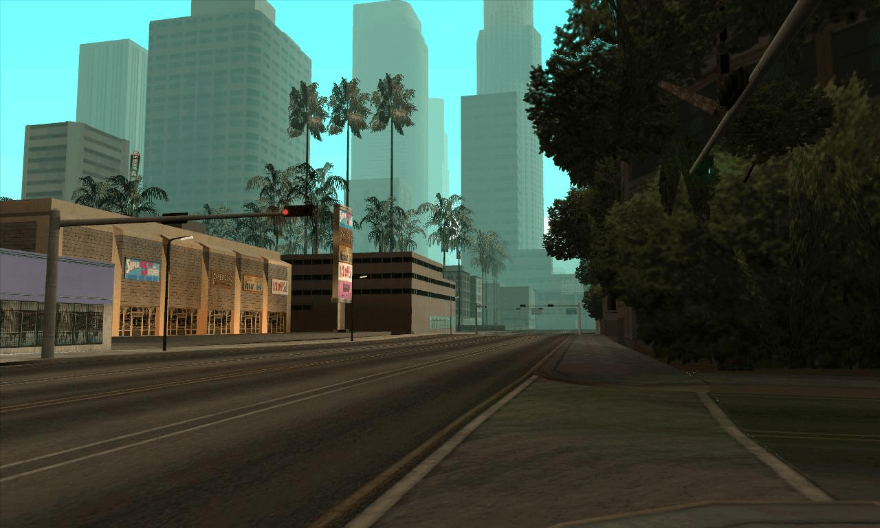 Imagem de um dos espaços de San Andreas completamente vazio. Na imagem vê-se uma estrada com arranha-céus como pano de fundo, e uma série de outros edifícios e palmeiras num plano mais aproximado.